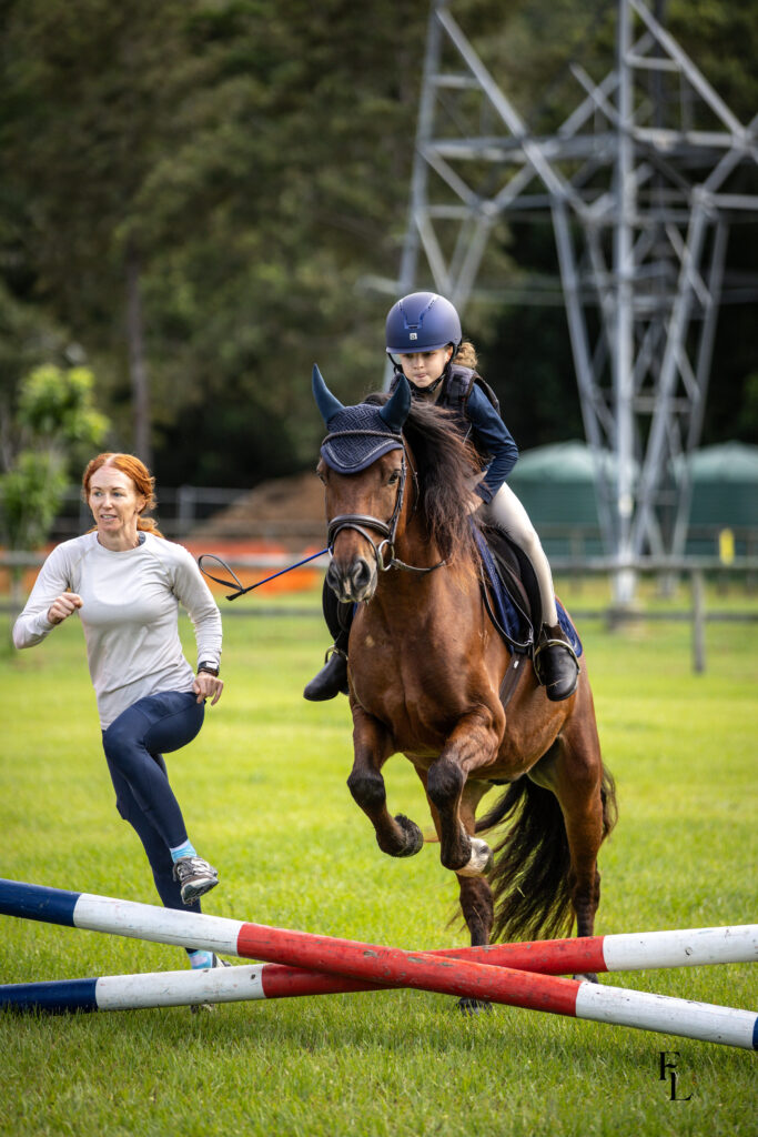 Mum daughter and pony jumping