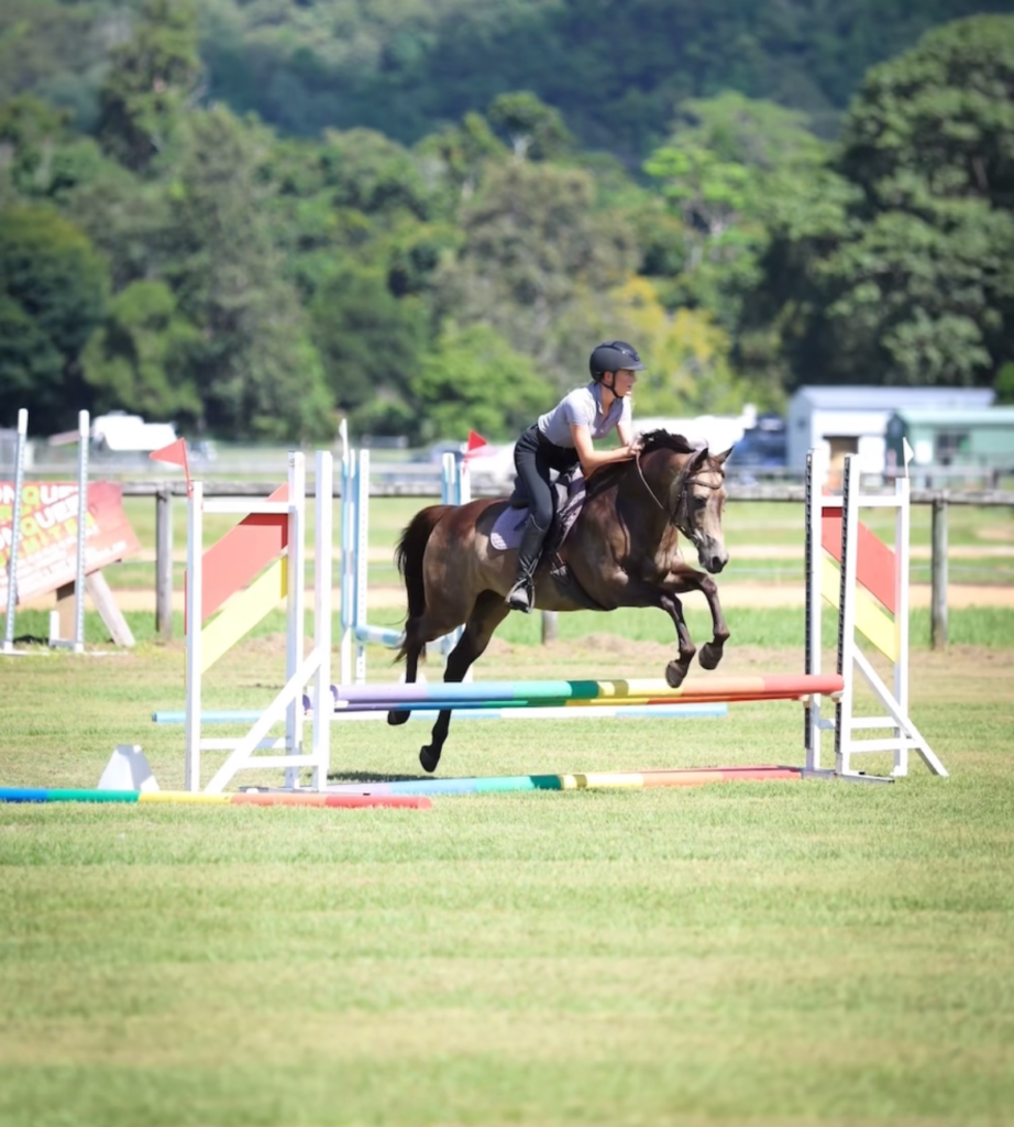 SEG rider clearing a jump during a showjumping event