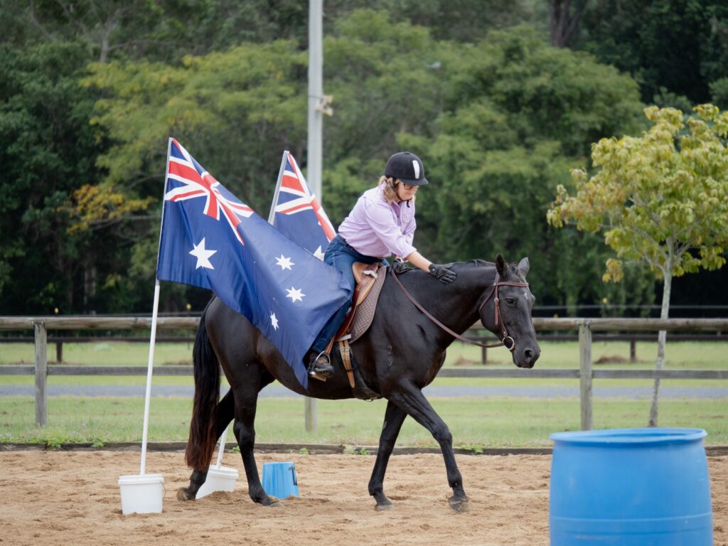 SEG members with the Australian flag celebrating at an equestrian event